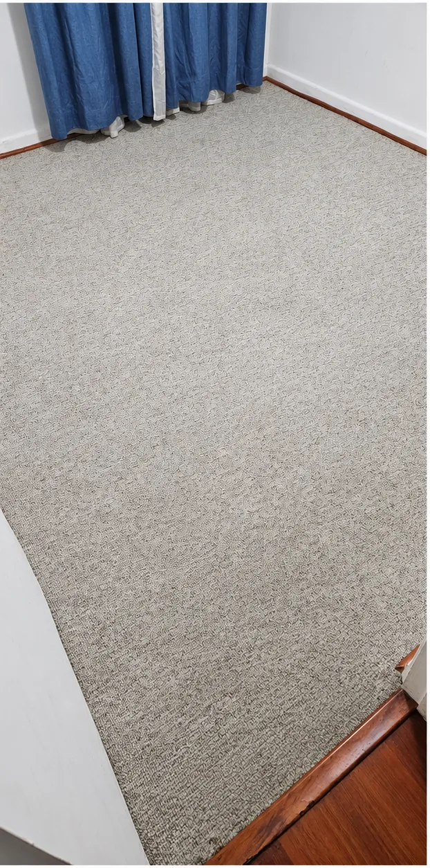 El mismo cubrepiso gris después del lavado, con tono más uniforme